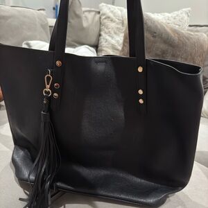 Black tote with gold metal and tassel